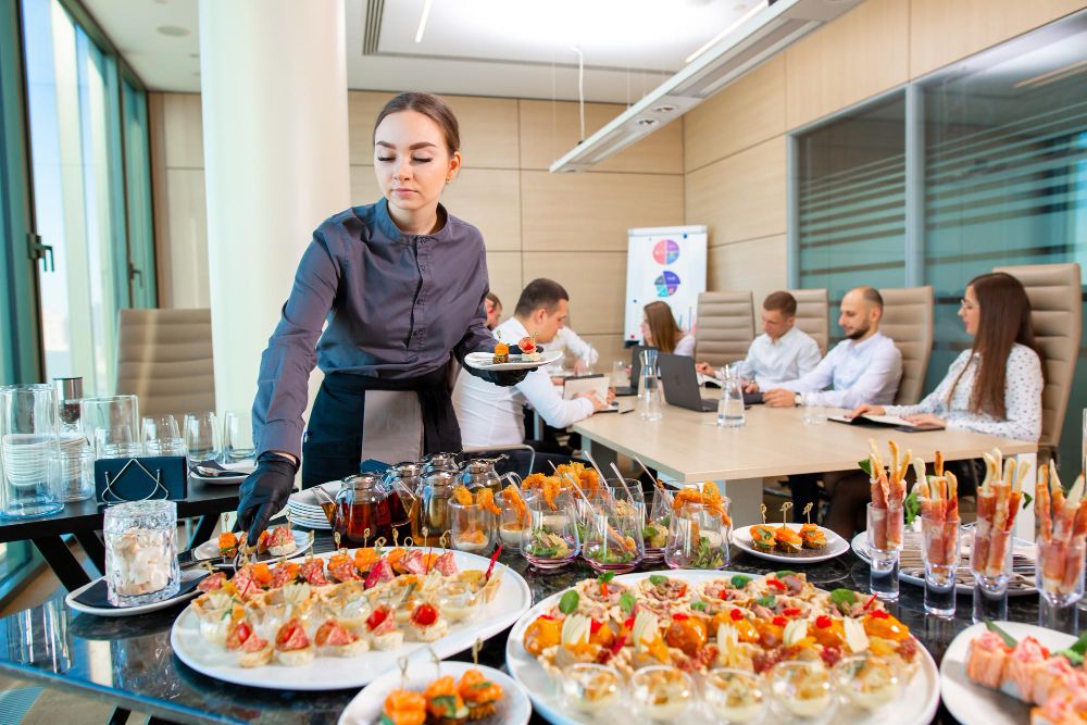 a-restaurant-waiter-serves-an-offsite-banquet-in-the-officexa