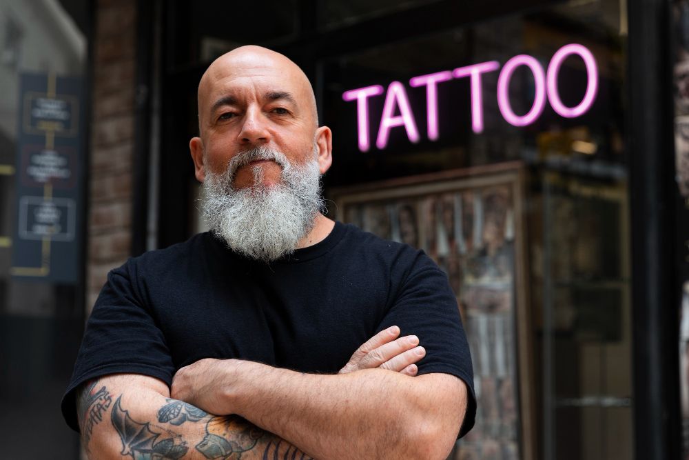 experienced-tattoo-artist-in-front-of-his-studio
